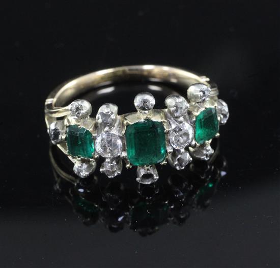 A Georgian gold and silver, three stone emerald and diamond half hoop triple cluster ring, size K.